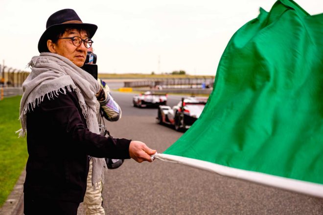 グリーンフラッグを振るジャッキー・チェン