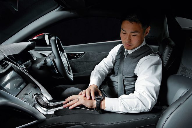 塚越はスーツ姿でホンダNSXに乗り込み、サーキットを転戦している